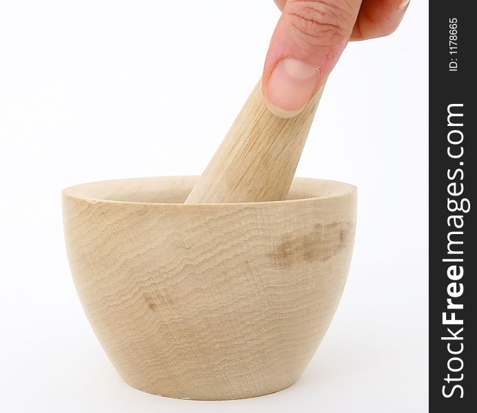 Female hand grinding the mortar and pestle, over white, macro closeup, close-up with copy space. Female hand grinding the mortar and pestle, over white, macro closeup, close-up with copy space.