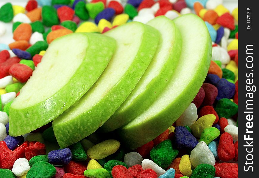 Sliced apple and funny colors stones