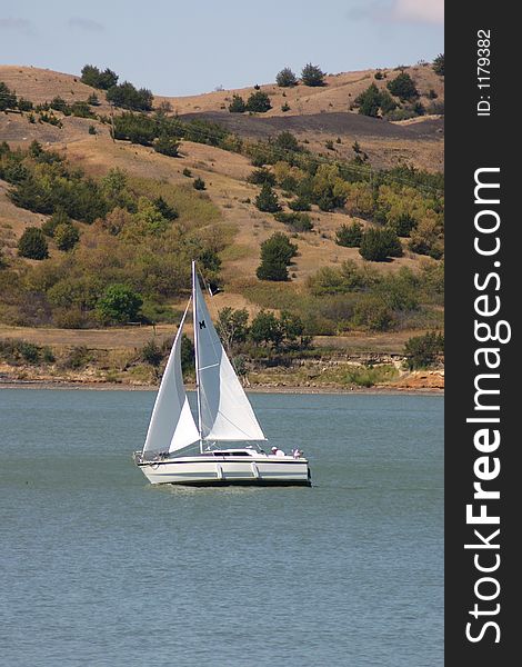 Sailboat sailing on a beautiful summer day. Sailboat sailing on a beautiful summer day