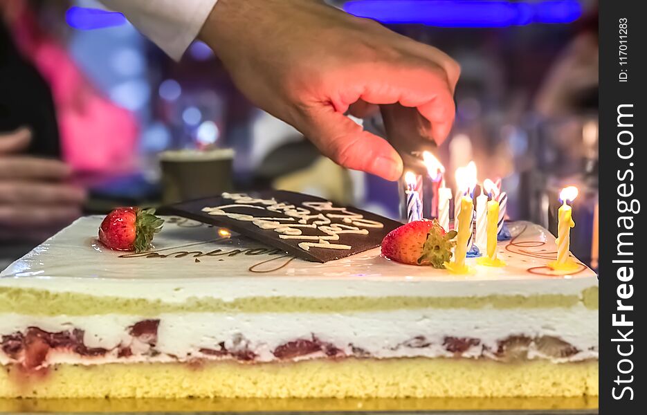 Lighting candles on cake celebrating birthday. Lighting candles on cake celebrating birthday