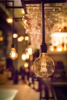 Vintage Lamp Bulb With Bar Or Cafe Night Abstract Background Royalty Free Stock Images
