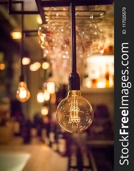 Vintage lamp bulb with blurred bar or cafe night abstract background