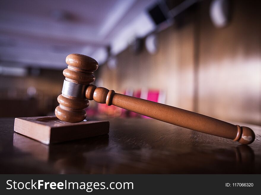 Color image of a hammer in a courtroom.