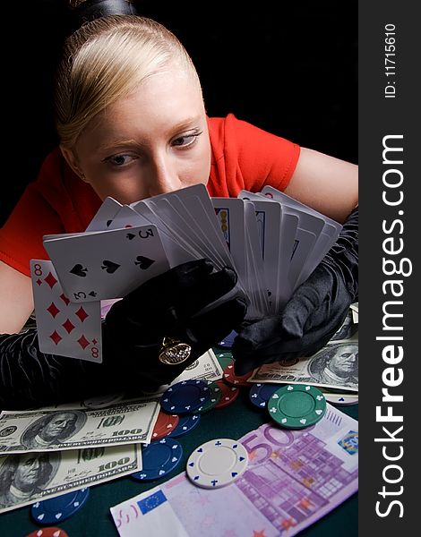 Blond girl holding bunch of playing cards. Blond girl holding bunch of playing cards