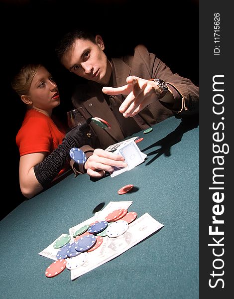 Young man throwing chips on the table while playing cards. Young man throwing chips on the table while playing cards