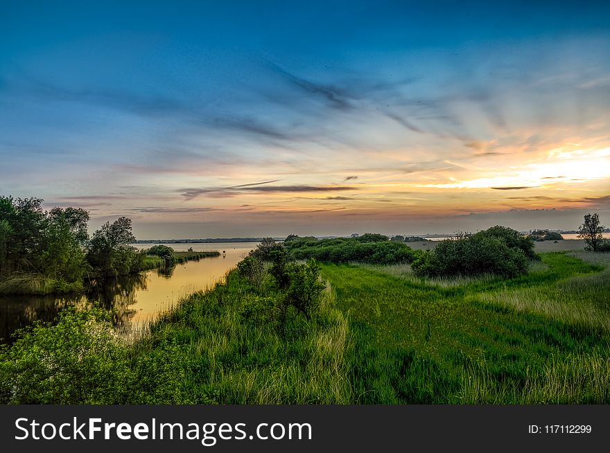 Landscape Photography Of Green Grass And Sea