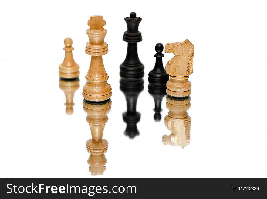 Photo of Black and Beige Wooden Chess Pieces With White Background