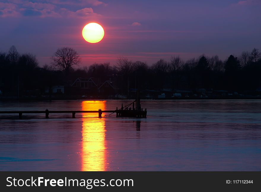 Boat Dock on Body of Water during Golden Hour