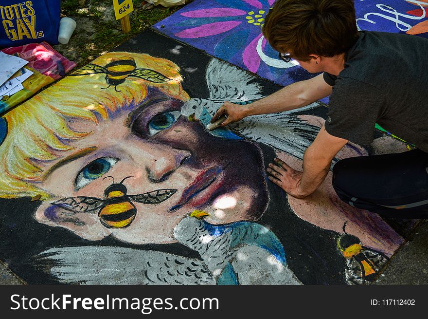 Man Painting Face of Human and Bird