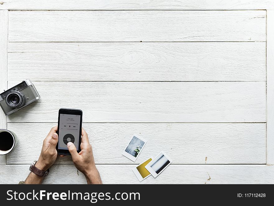 Flat Lay Photography of Person Holding Android Smartphone