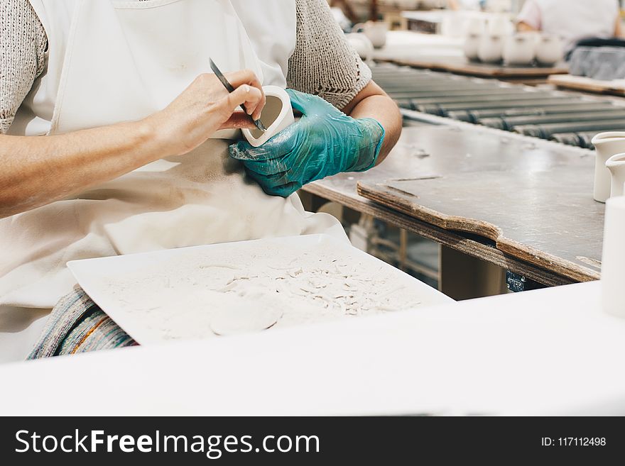 Person Wearing Green Glove While Carving