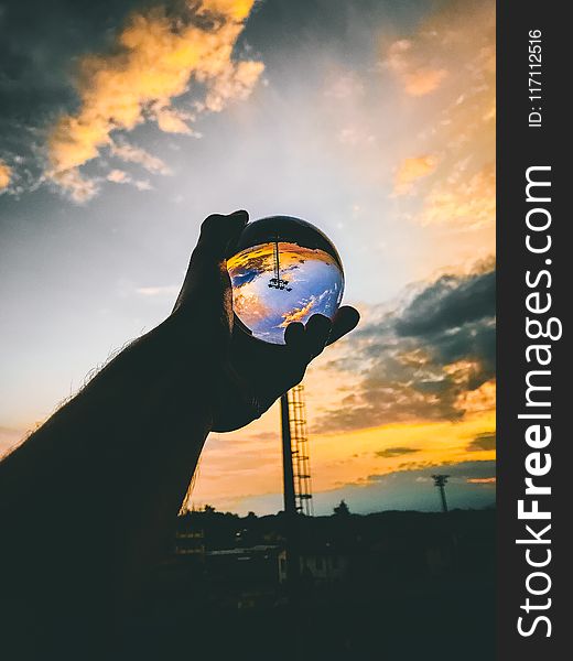 Person Holding Glass Ball