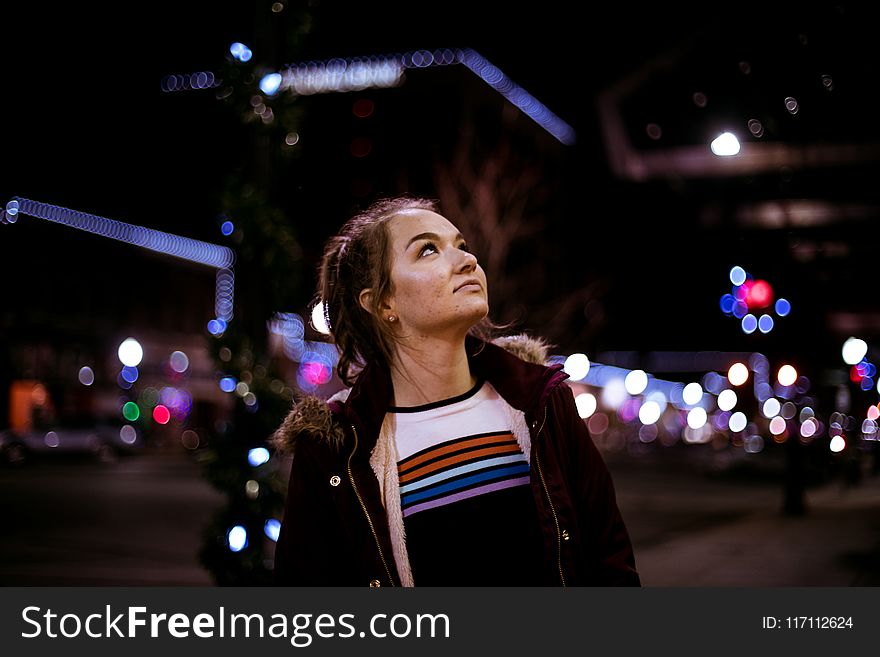Woman Looking Up during Night Time