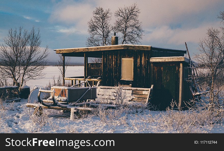 Brown Wooden Barn Surrounded By Snow