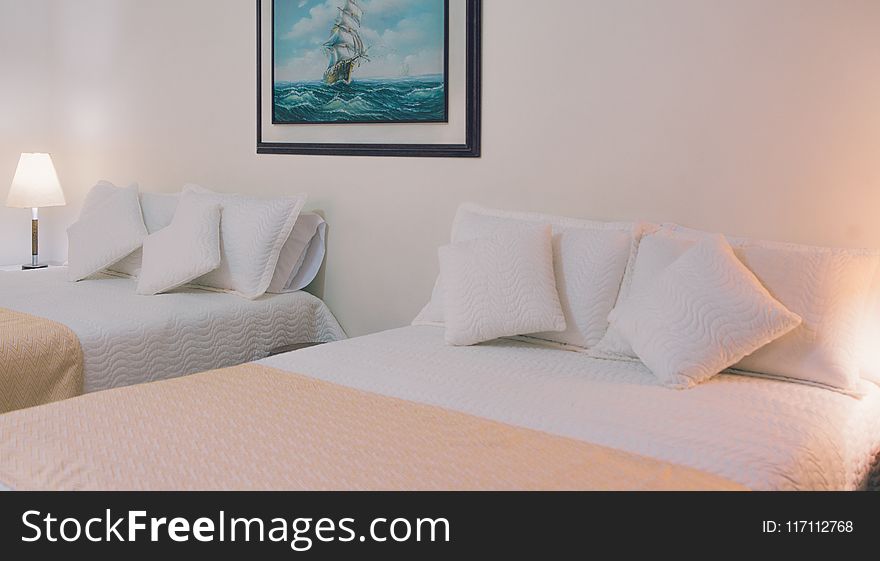 Two White Bed Mattresses Near Wall