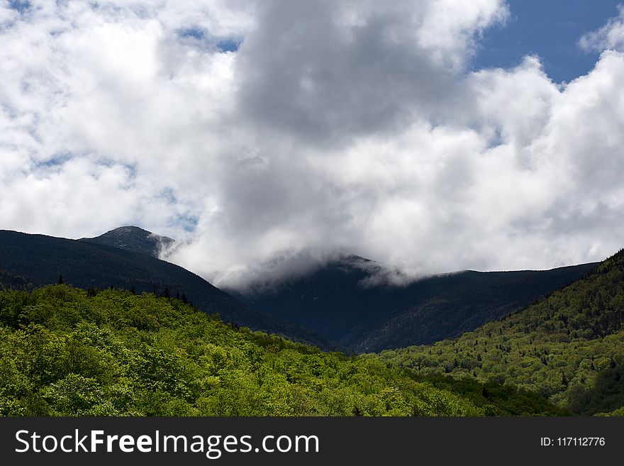 Green Hill Under White Clouds And Blue Sky