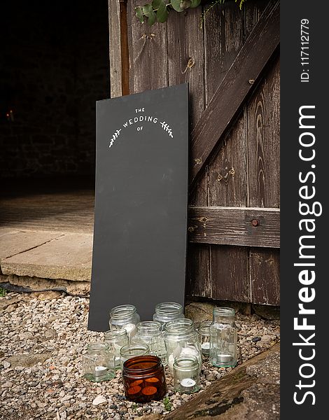 Clear Glass Jars Near Black Board