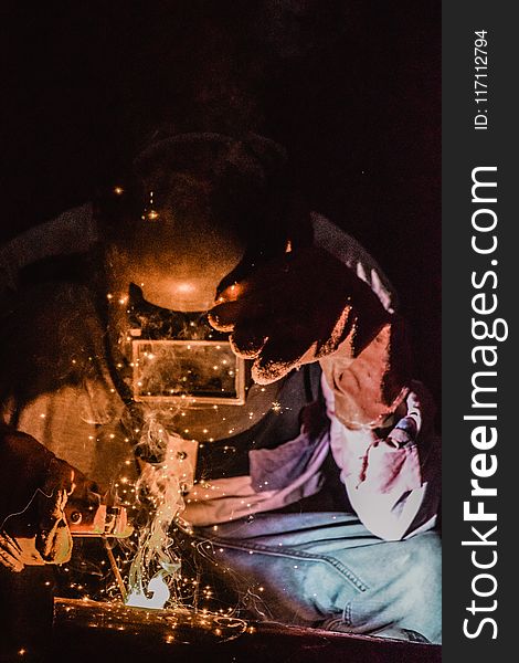 Photography Of A Person Wearing Welding Mask