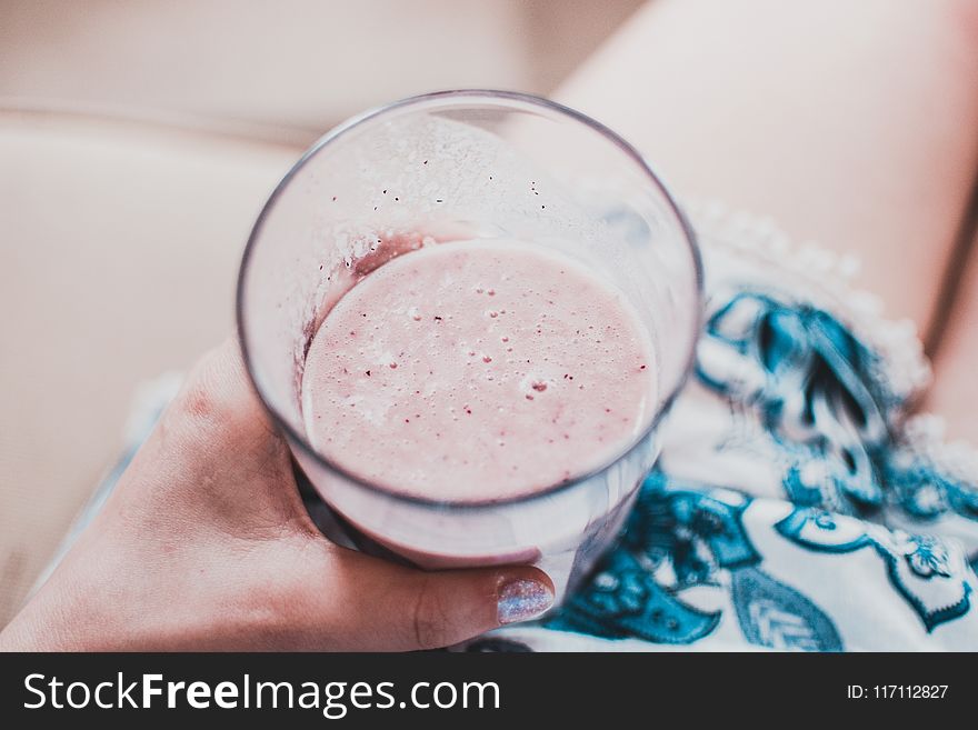Person Holding Clear Drinking Glass With Fruit Shake Close-up Photo