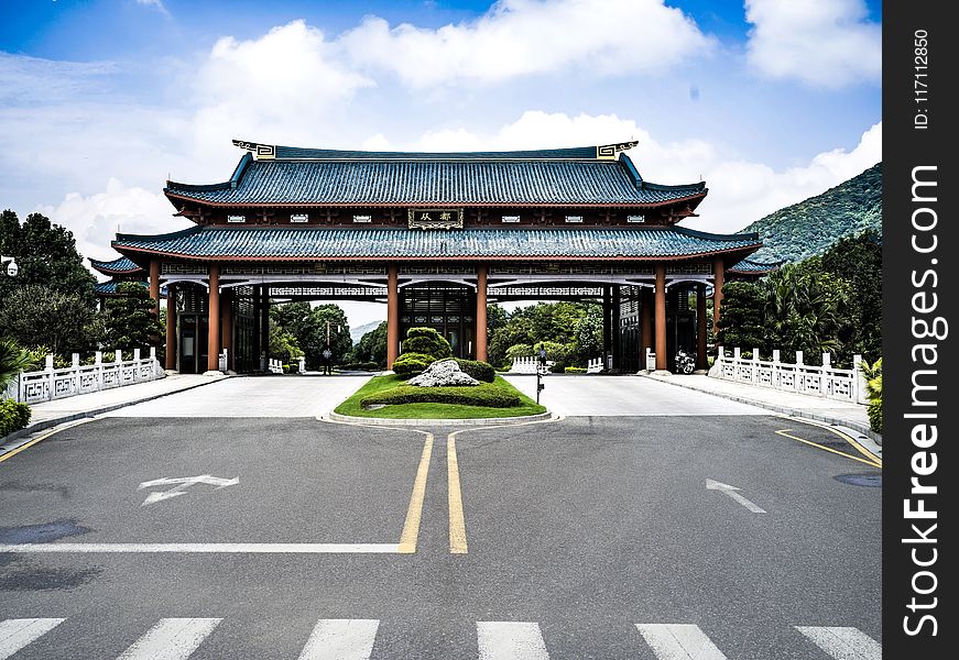 Blue And Brown Temple Near Gray Pavement Road