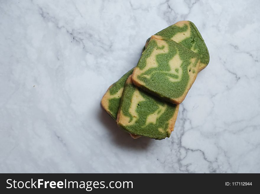 Green and Brown Pastries on White Surface