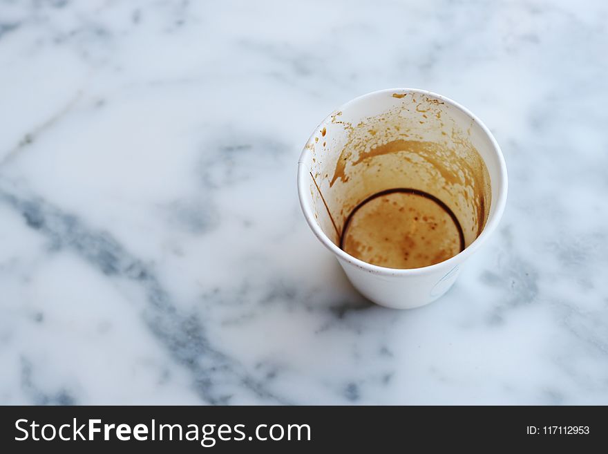 White Paper Cup on Top of Gray Marble Surface