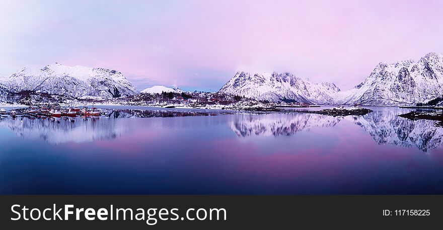 Landscape with beautiful winter lake and snowy mountains at sunset at Lofoten Islands in Northern Norway. Panoramic view. Landscape with beautiful winter lake and snowy mountains at sunset at Lofoten Islands in Northern Norway. Panoramic view