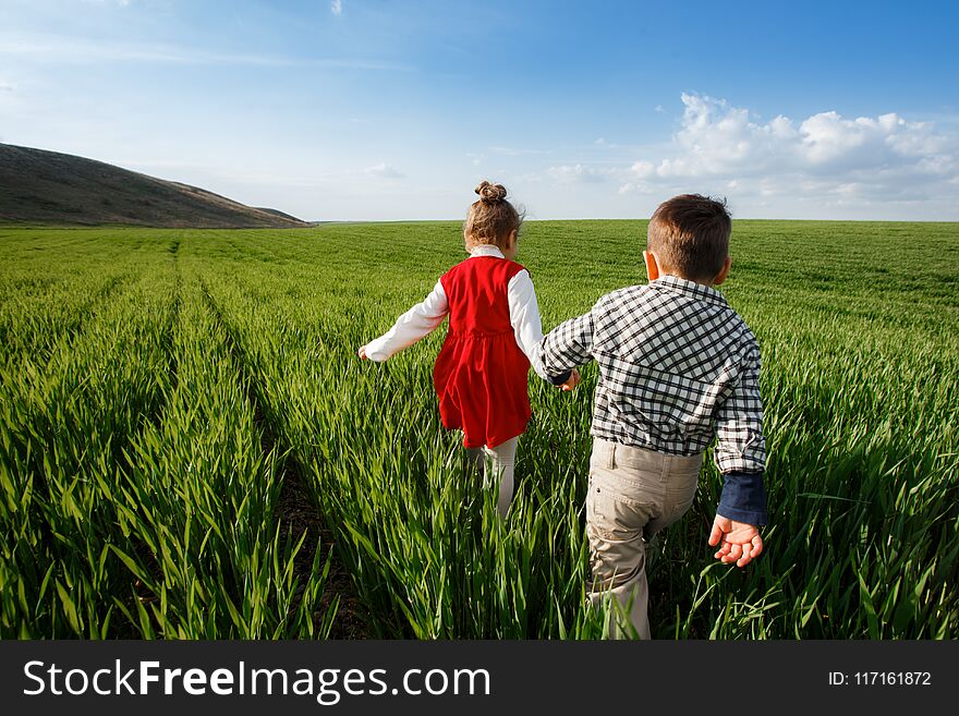 Happy Children Running In The Meadow