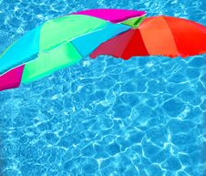 Bright Color Parasols Over Turquoise Blue Pool Stock Photo