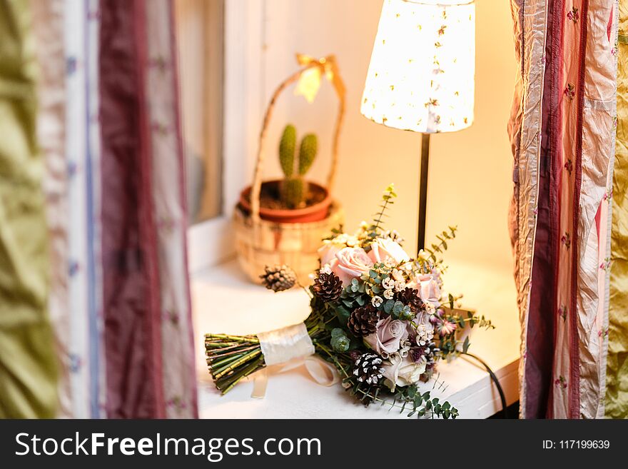 Wedding Bride Bouquet Of Fresh Floral. White Ranunculus Flowers On Table. Warm Evening Atmosphere