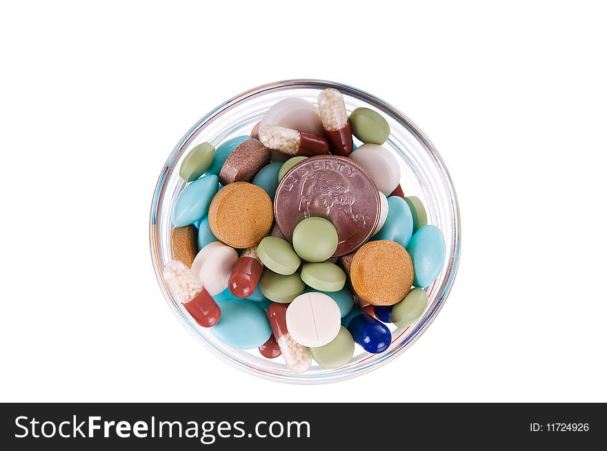 Fifty cents in glass saucer full of different pills on white background. Fifty cents in glass saucer full of different pills on white background