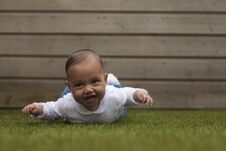 Adorable Cute Little Baby Girl Lying On Belly On Grass Surface W Stock Image