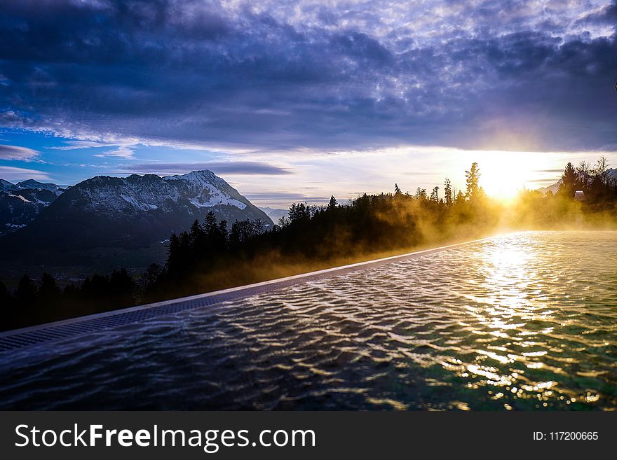 Infinity Pool Near the Forest during Golden Hour