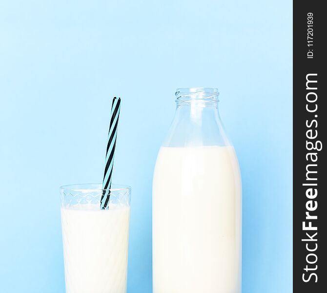 Milk In A Transparent Glass Bottle And In A Glass Glass Cup With A Tube