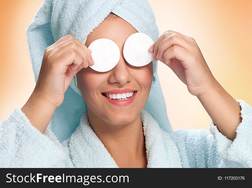 Woman Holding Cotton Pads On Her Eyes