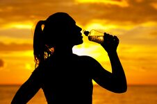 Silhouette Of Young Athletic Woman Drinking Water Royalty Free Stock Photo