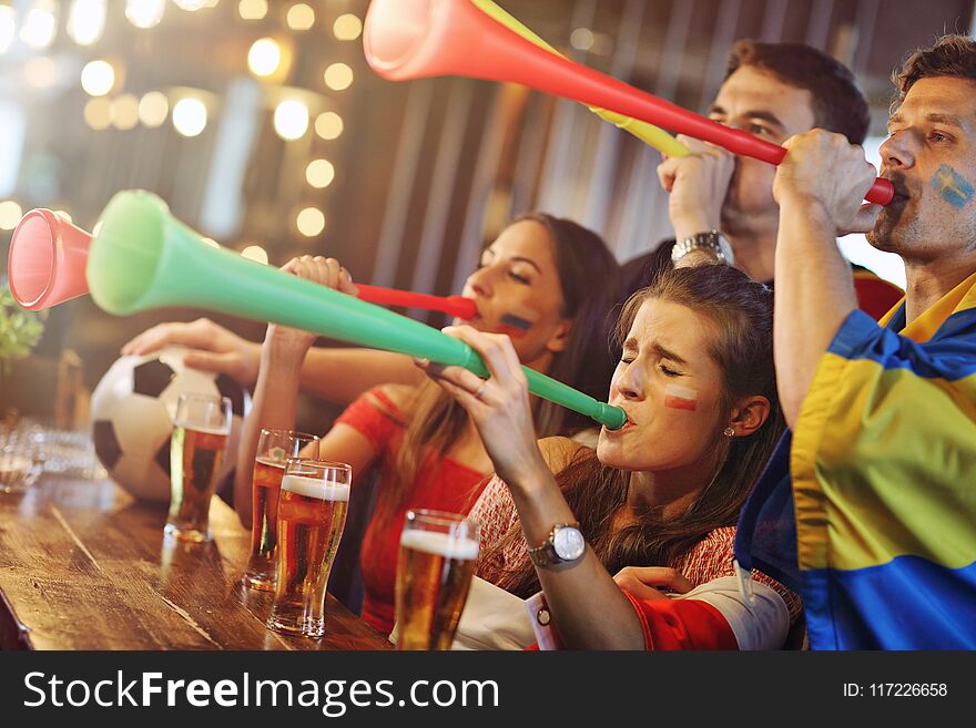 Group Of Friends Watching Soccer In Pub