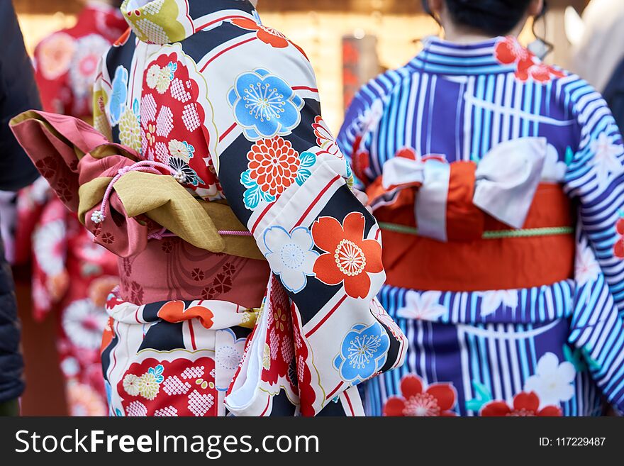 Young girl wearing Japanese kimono standing in front of Sensoji Temple in Tokyo, Japan. Kimono is a Japanese traditional garment. The word `kimono`, which actually means a `thing to wear`
