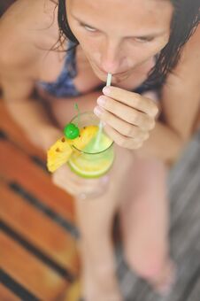 Young Girl At Swimming Pool Drinking Cocktail Royalty Free Stock Images