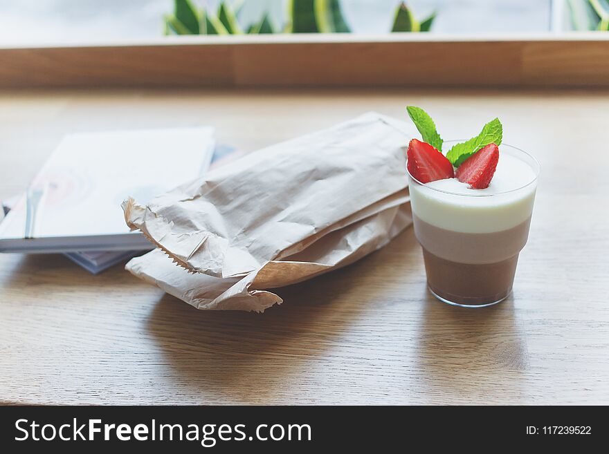 Coffee dessert with strawberry and leaves of mint, soft focus background