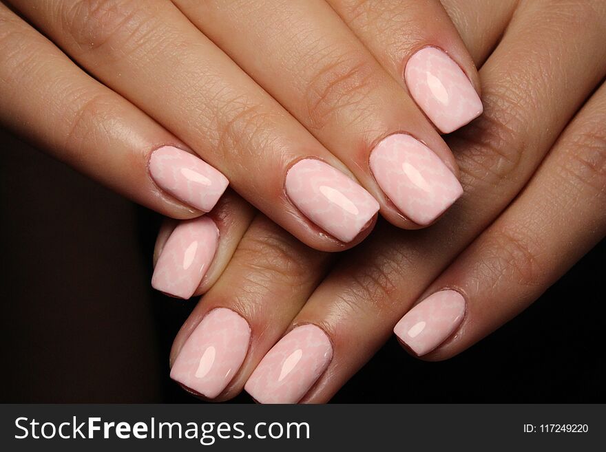 beautiful pink nails on a trendy texture background