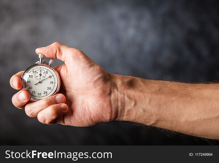 Analog stopwatch on black background