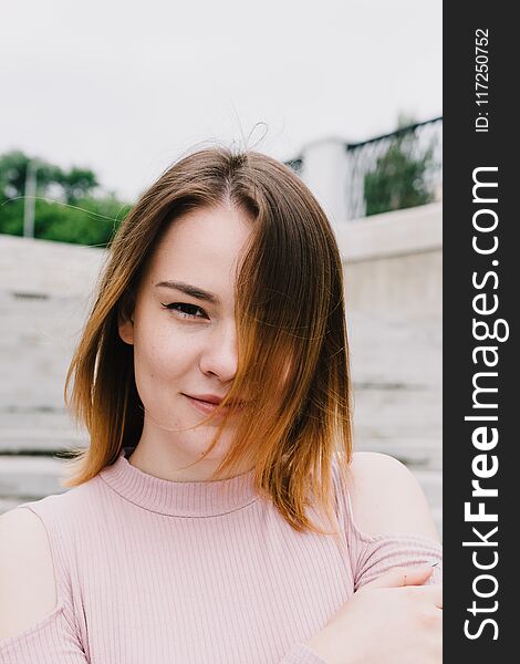 Portrait Of A Stylish Woman On A Concrete Wall Background.