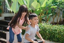 Kid Having Fun With Sister Riding A Bike Stock Photo