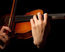Violin And Bow In Hands Of Musician, Isolated On Black Stock Photo