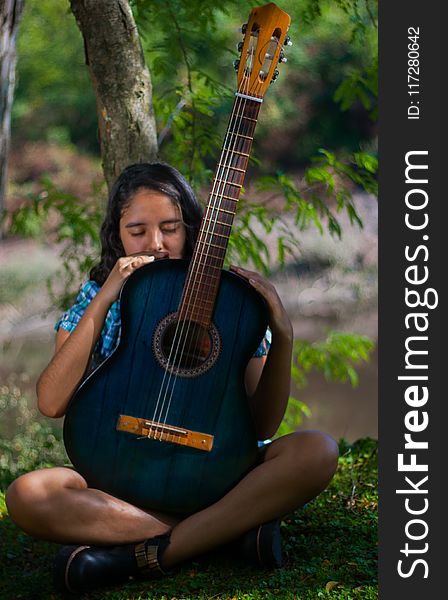 Woman Holding Blue Classical Guitar