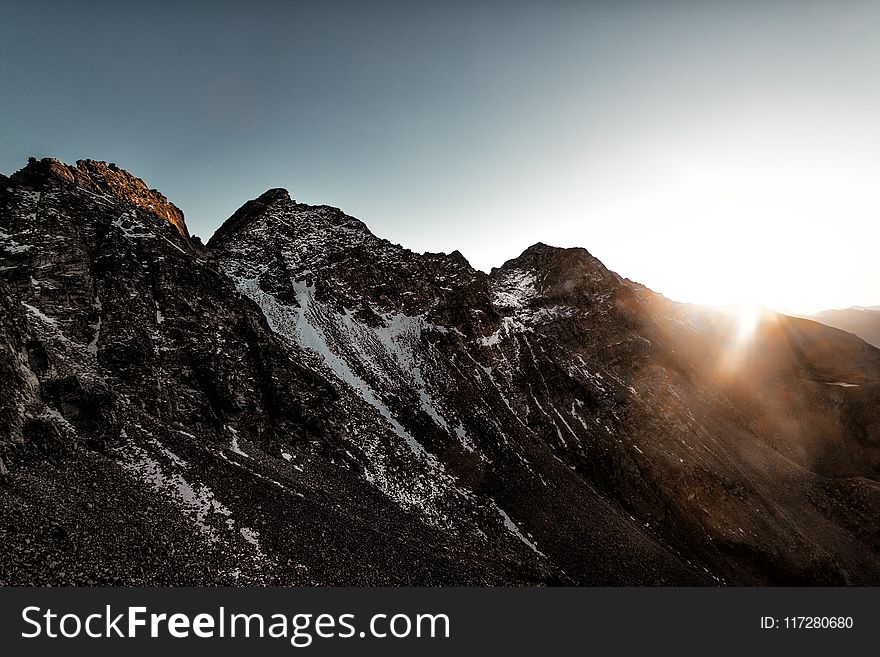 Gray Rock Mountain With White Snow during Sun Rise Aerial Photography