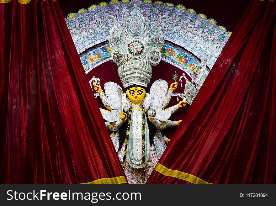 Red curtains getting revealing durga idol for worship