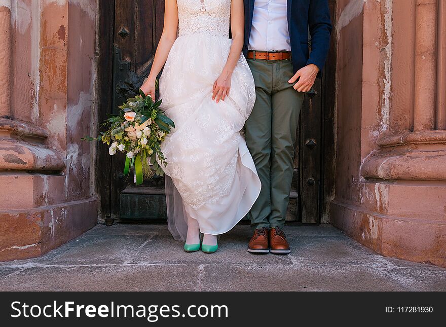 Stylish Bride And Groom Stand Door