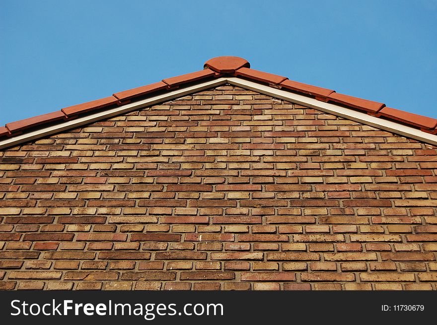 A roof with a wall of bricks